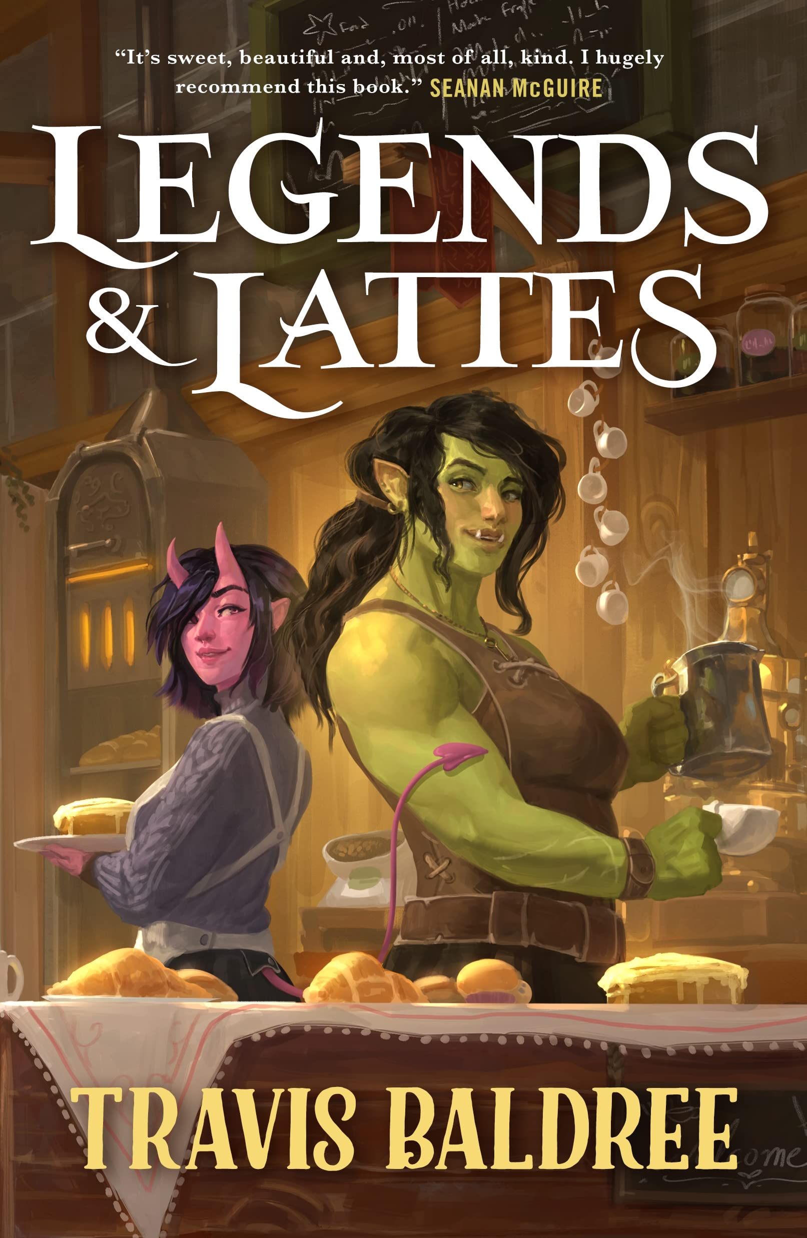 Book Cover showing a green orc and a pink creature standing back to back with their arms crossed behind a bakery counter.