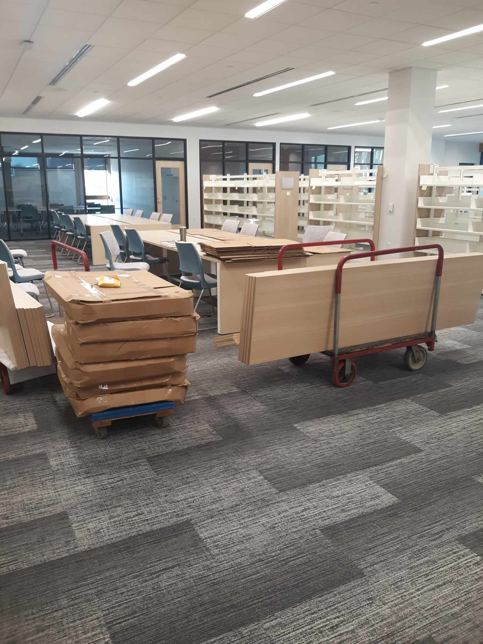 Shelves and the new computer stations being set up in the Adult Services area on the west side of the building.