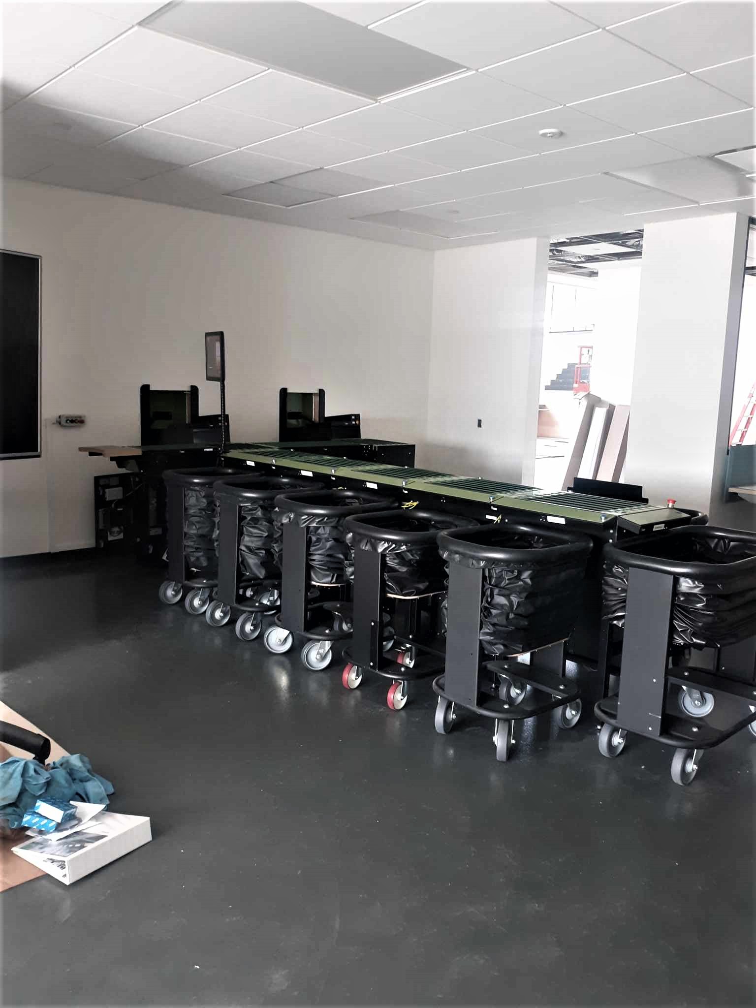 Machine that sorts material returned by patrons into departments is set up in the new circulation workroom space.