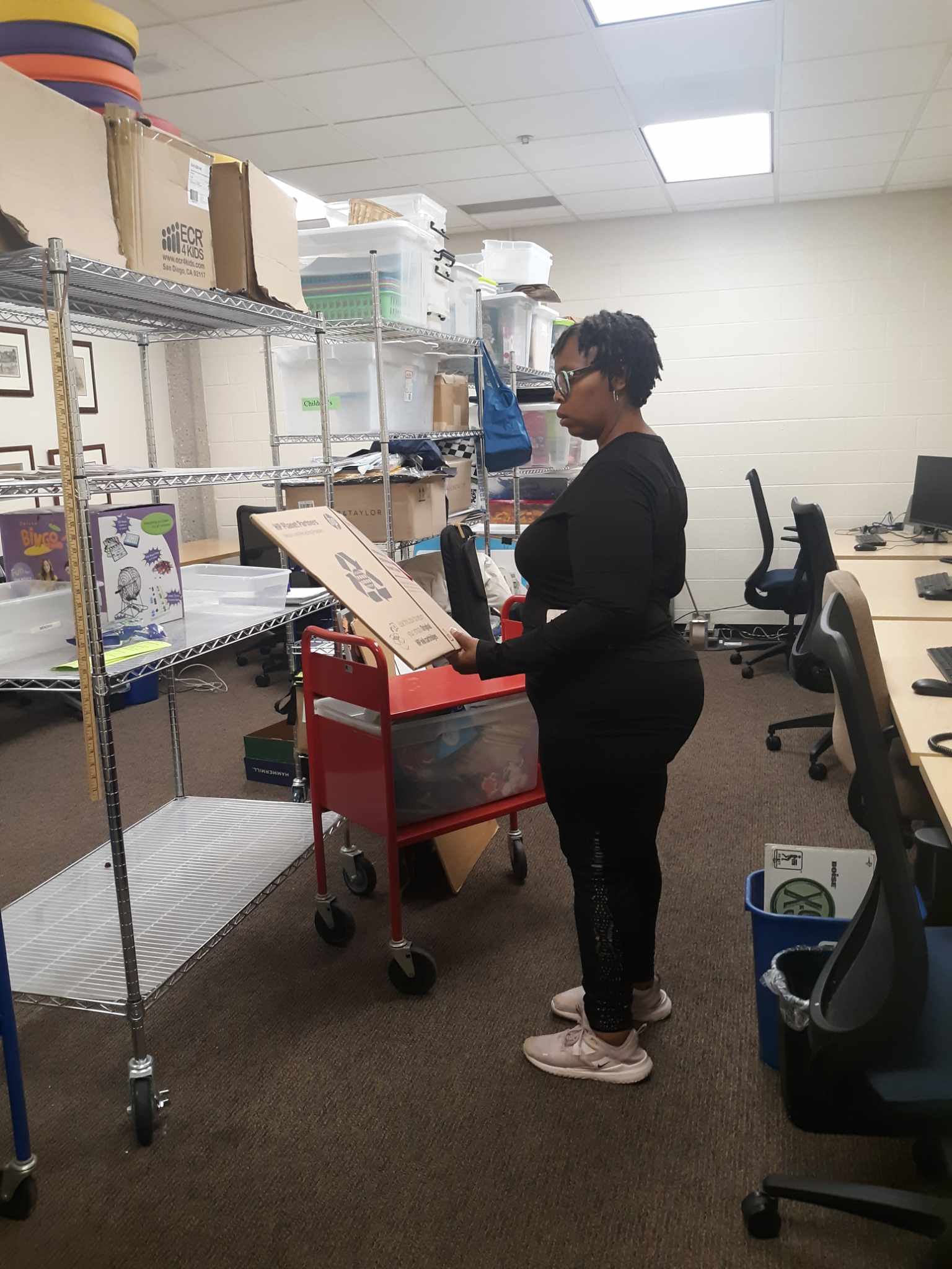 Staff moving items out of the Children’s Services work room.