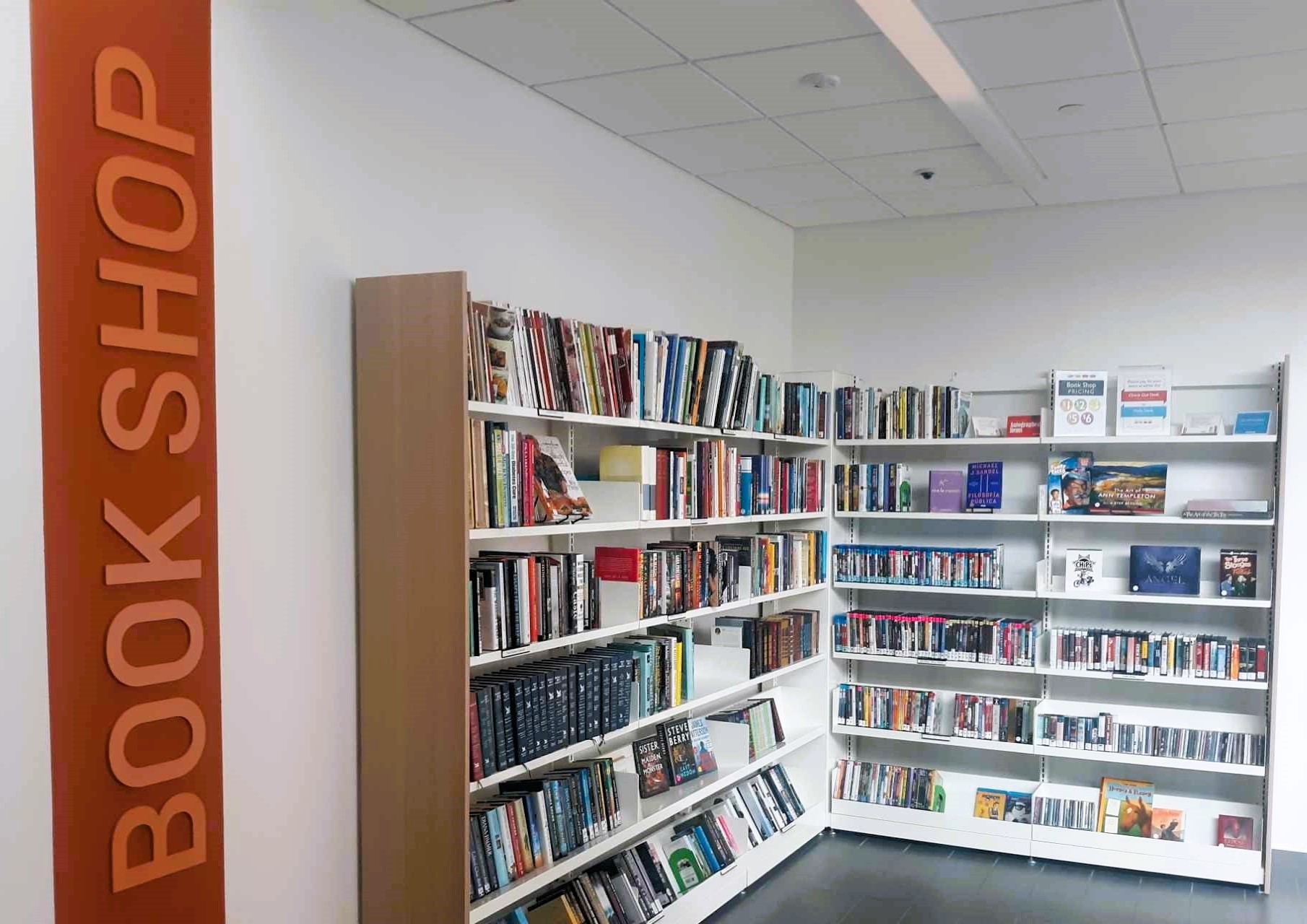 Image of Bloomington Library's stocked Book Shop Shelves where discarded and donated materials are sold to the public.