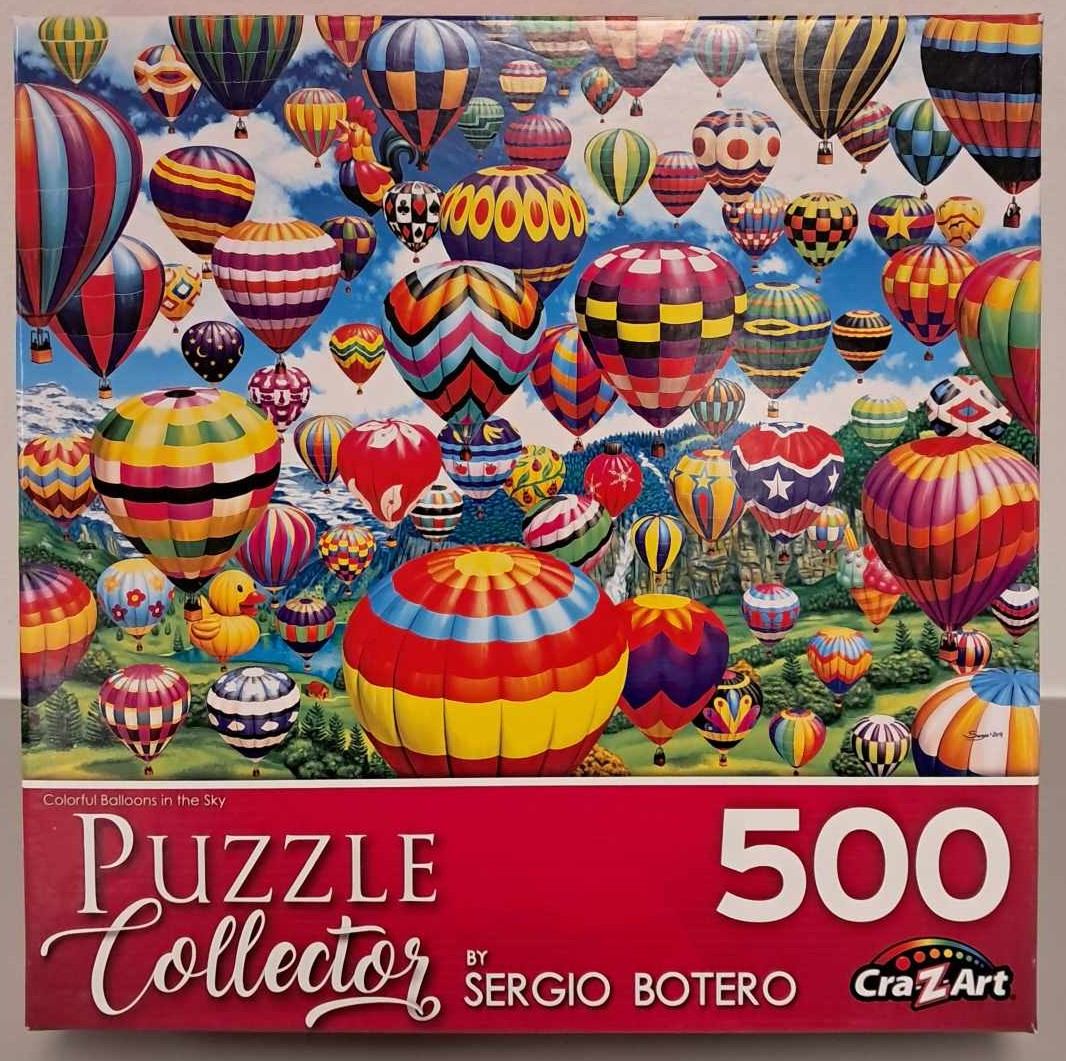 Puzzle cover of an artistic drawing of many hot air balloons in the sky of all different colors.
