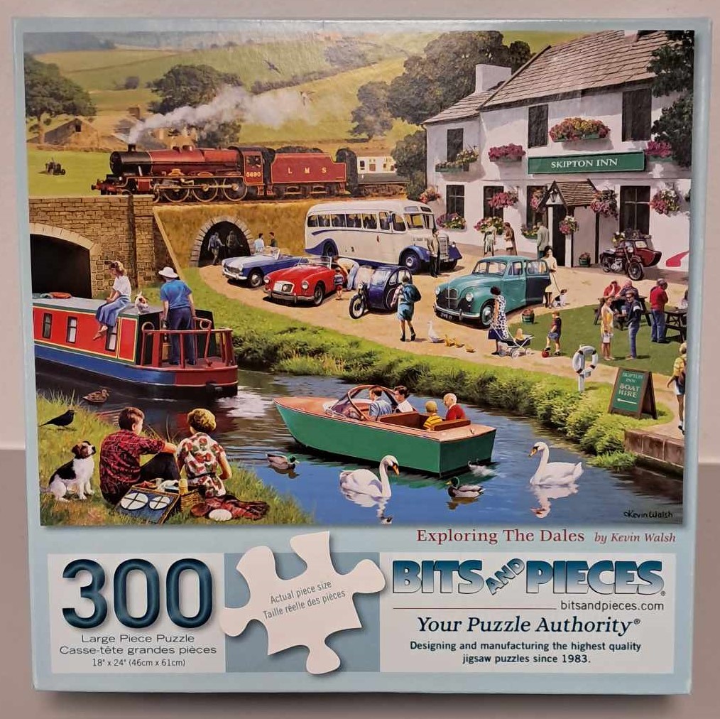 Puzzle cover with a cartoon drawing of people near a river. The river has boats in it and a bridge over the river with a train going past.