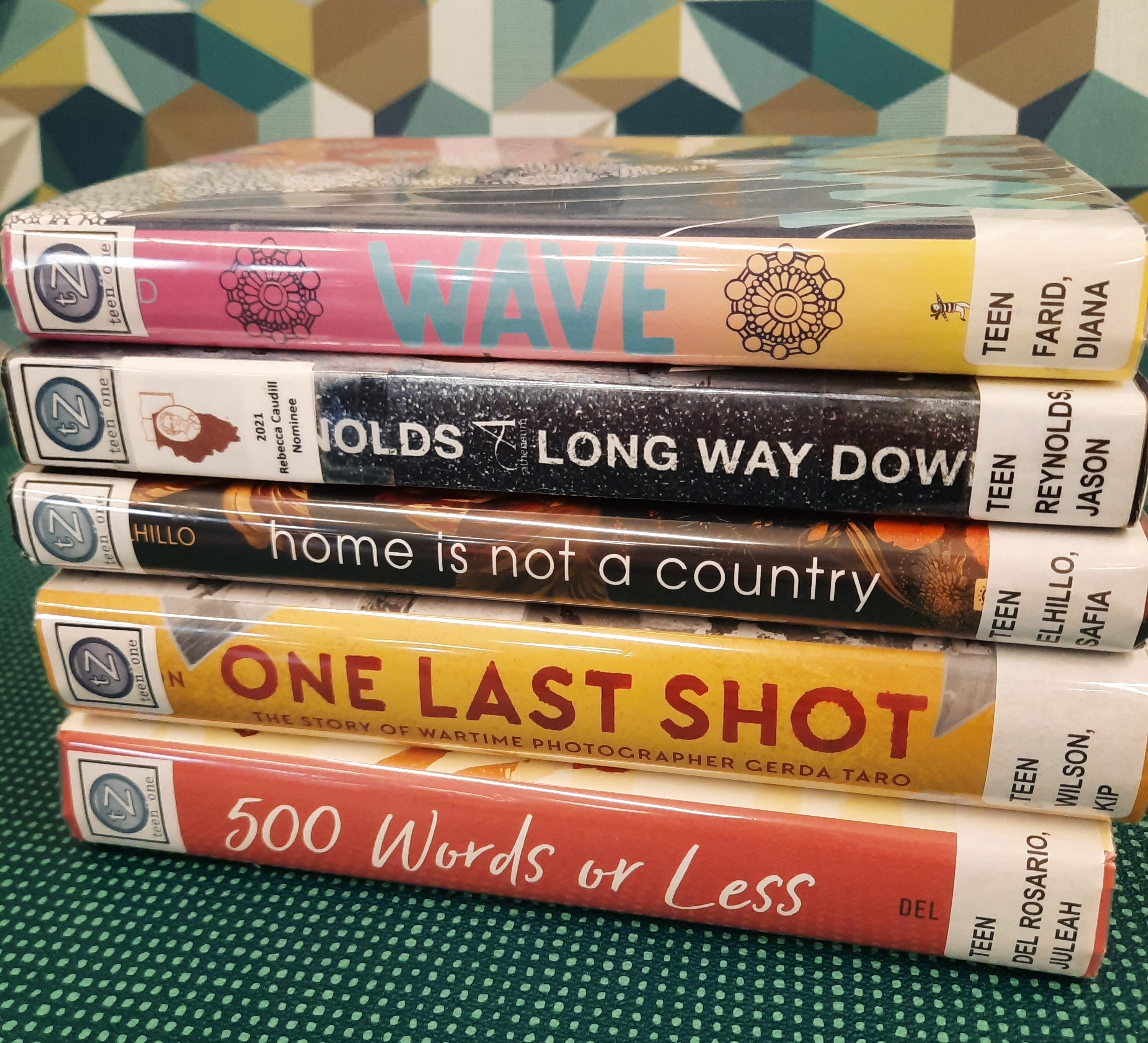 2025 April Book Stack Book stack showing the following titles: "Wave," "Long Way Down," "Home is not a country," "One Last Shot," and "500 Words or less"