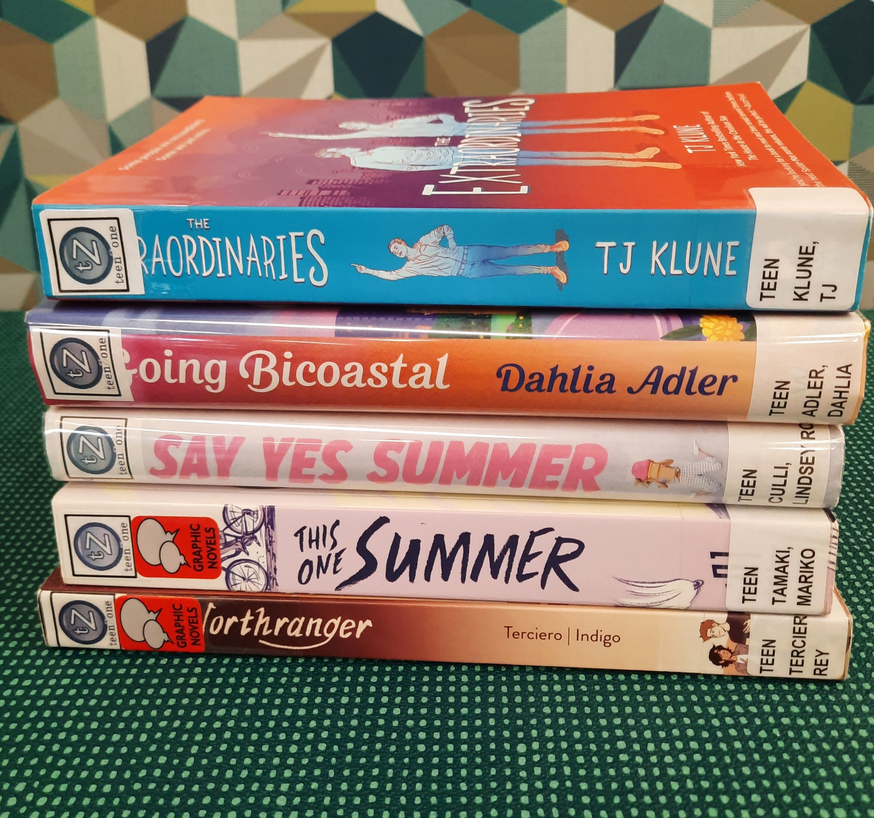 2025 July Book Stack Book Stack showing the following titles: "The Extraordinaries," "Going Bicostal," "Say Yes to Summer," "This One Summer," and "Northranger"
