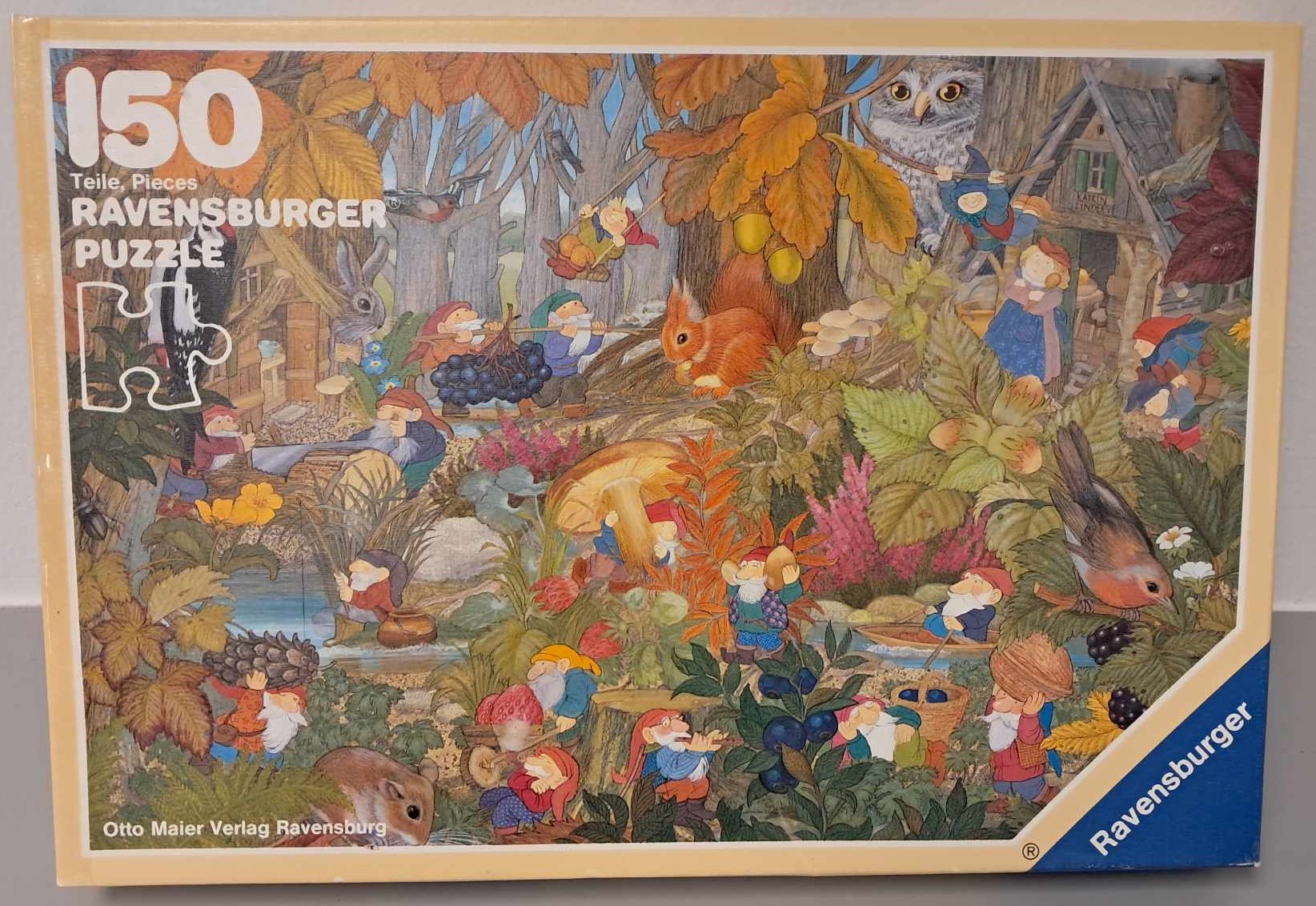 Puzzle cover with an illustration of different forest animals working along with small gnomes or elves to collect food.