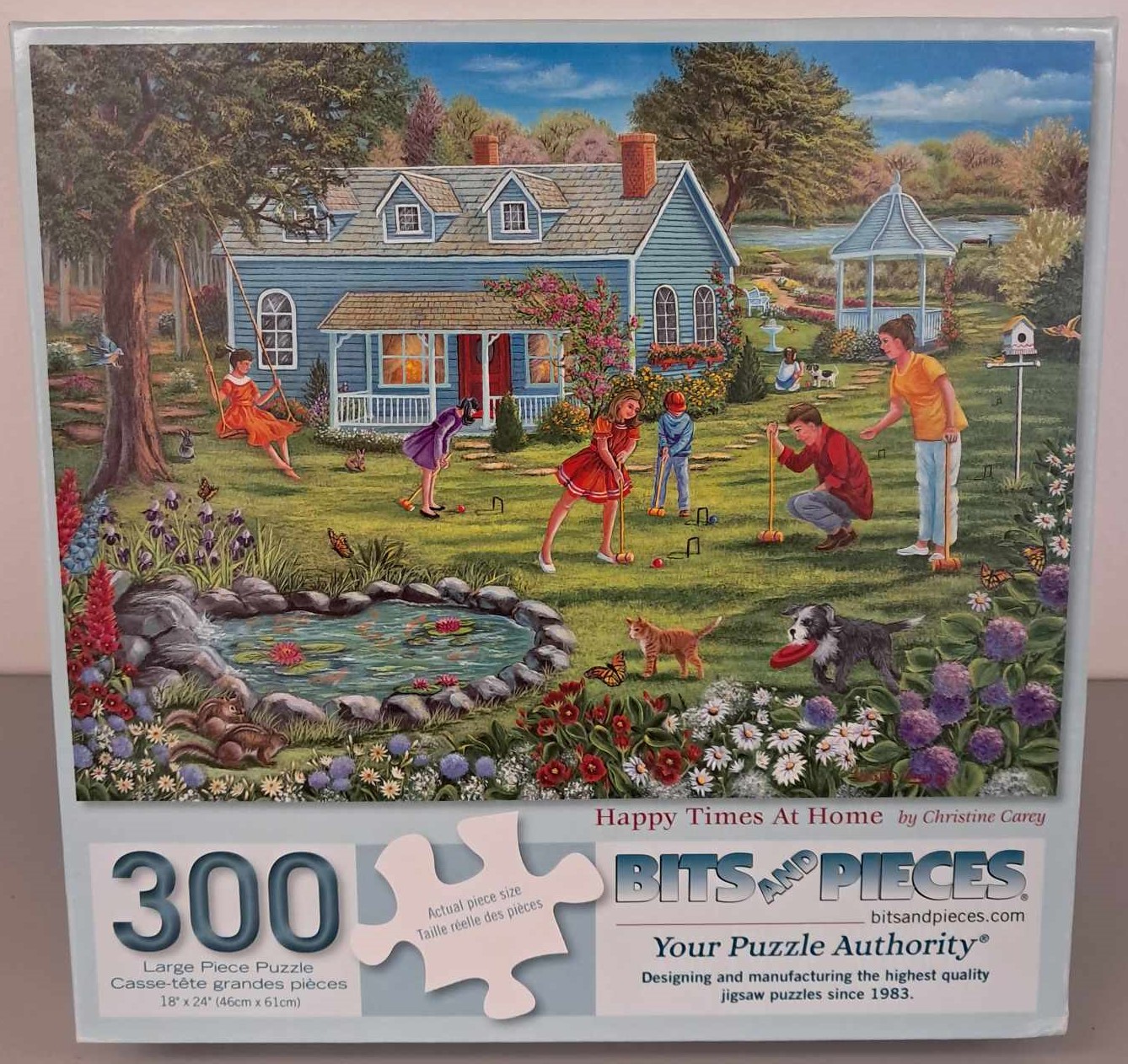 Puzzle cover showing an illustration of a family playing croquet in the back yard with a dog and a cat.