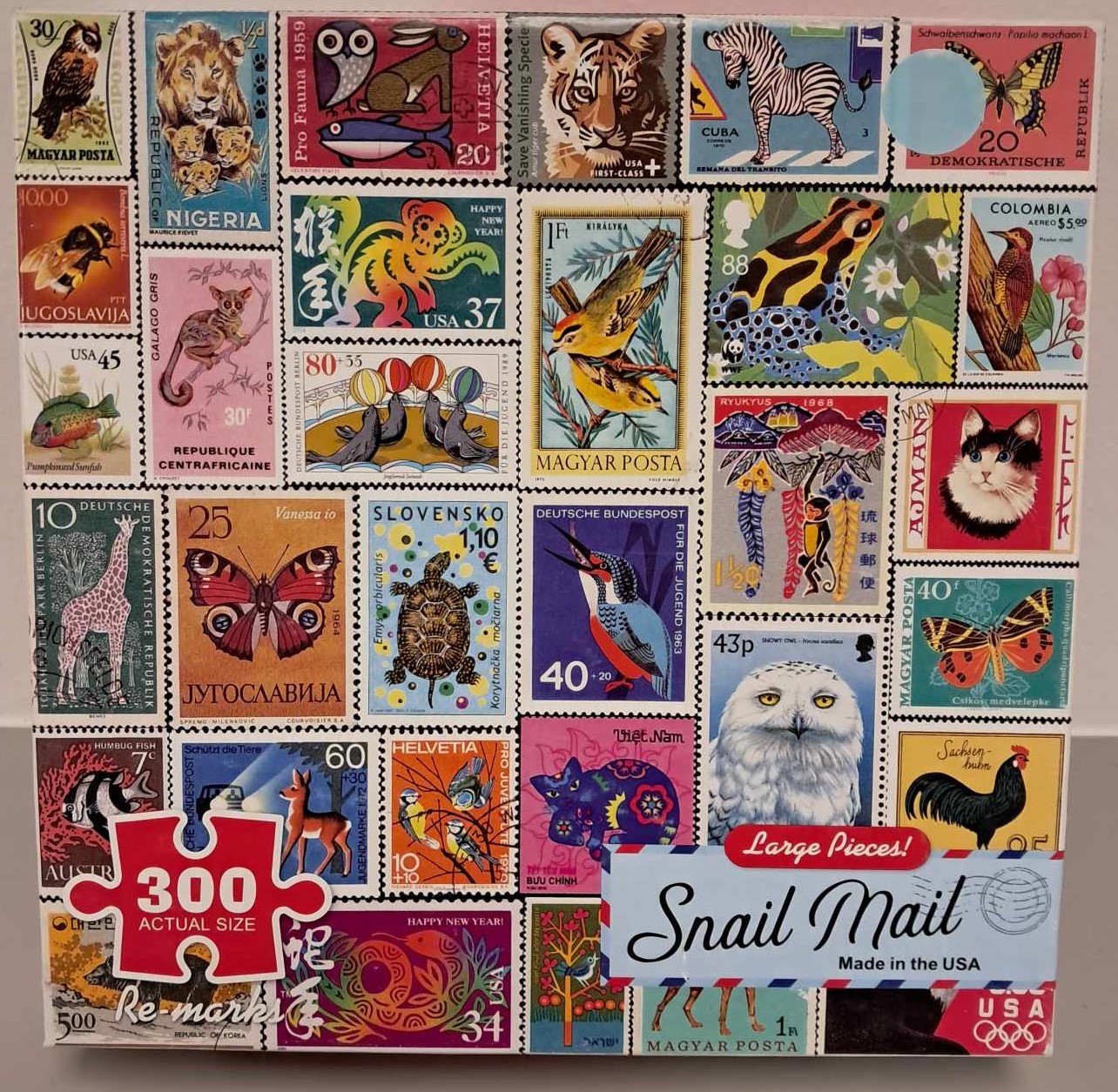Puzzle cover showing a collage of postage stamps with different animals on them.