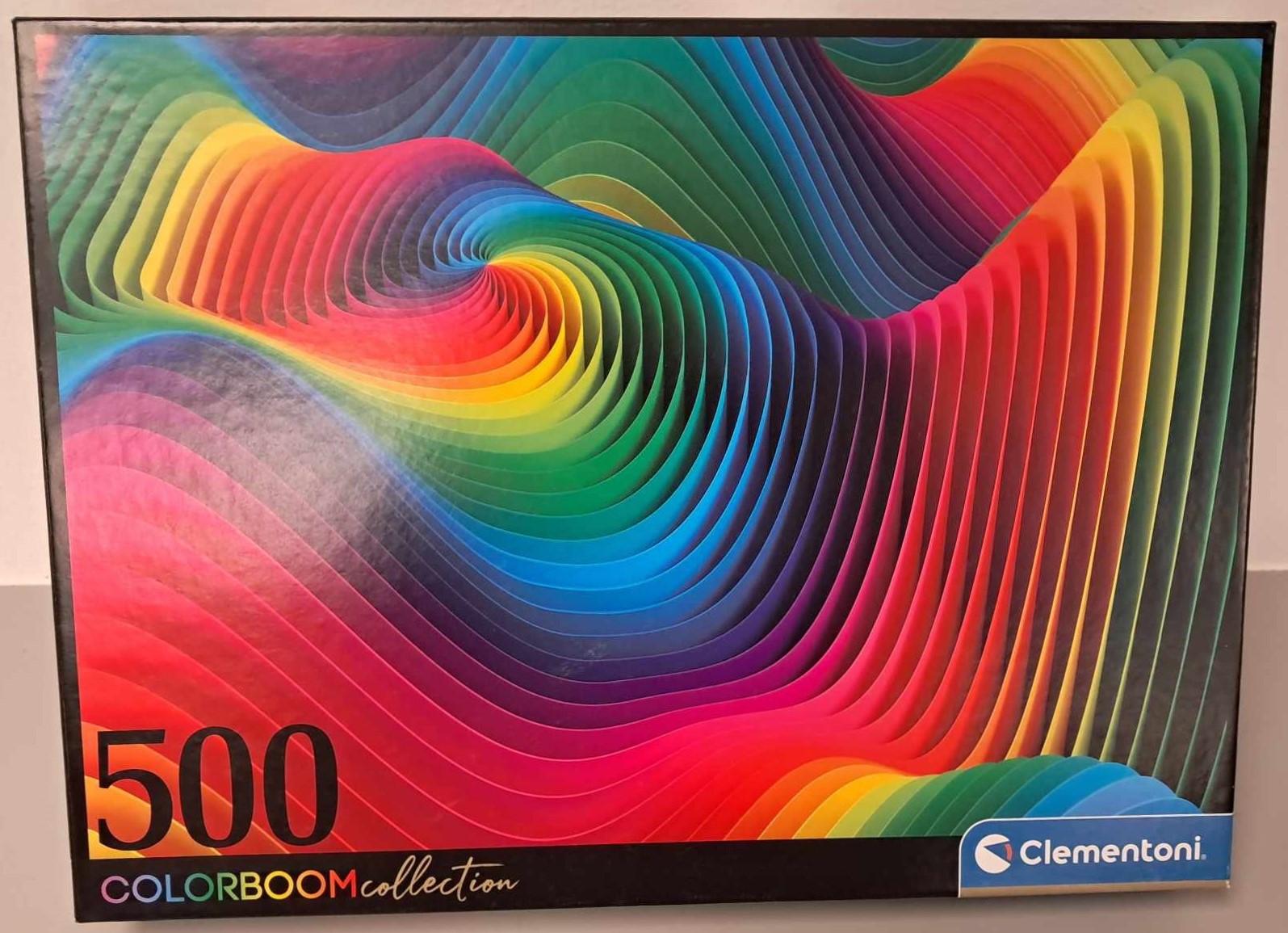 Puzzle cover showing geometrical waves layered in different colors.