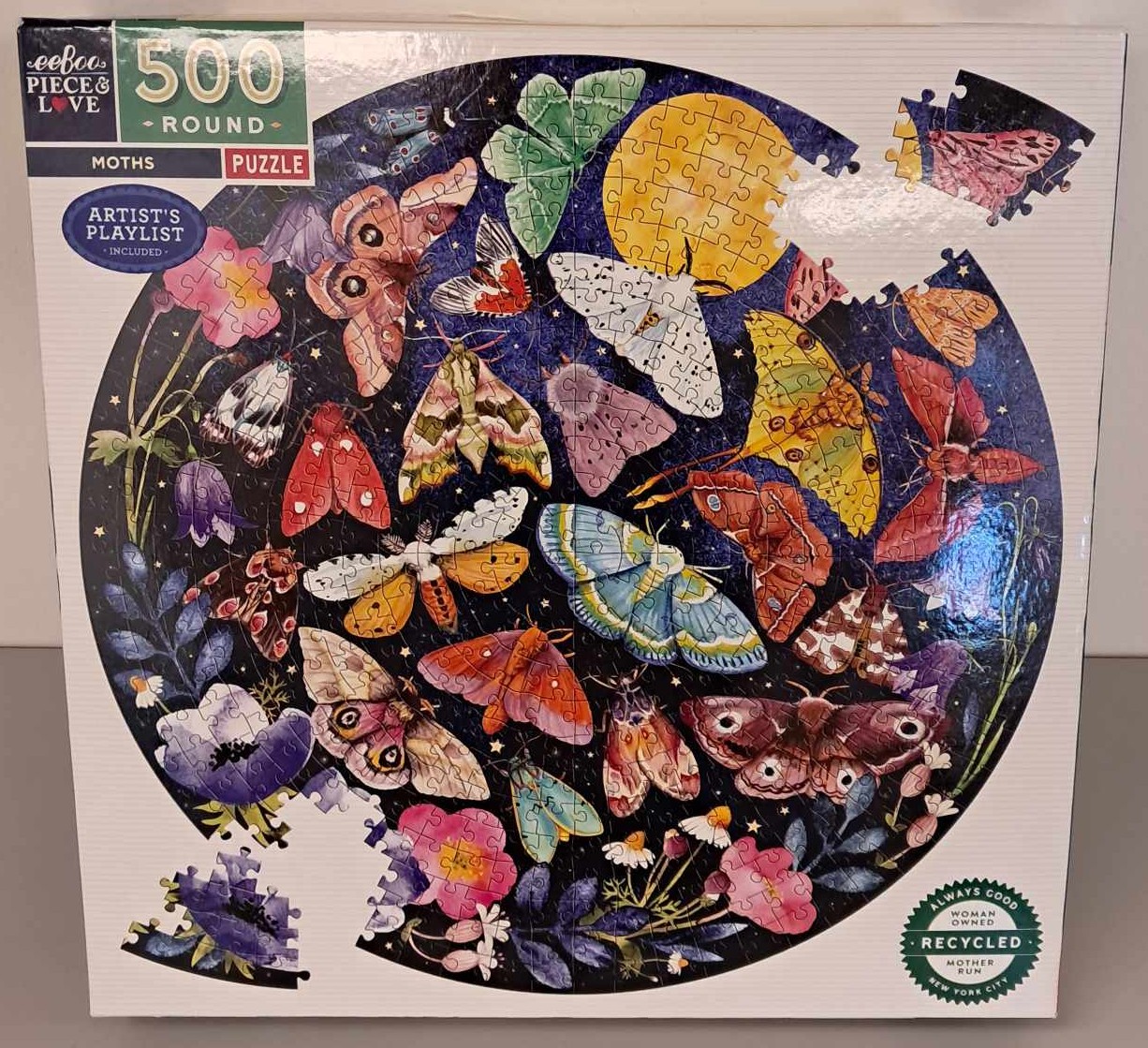 Puzzle cover showing a photo of different colored moths and flowers.