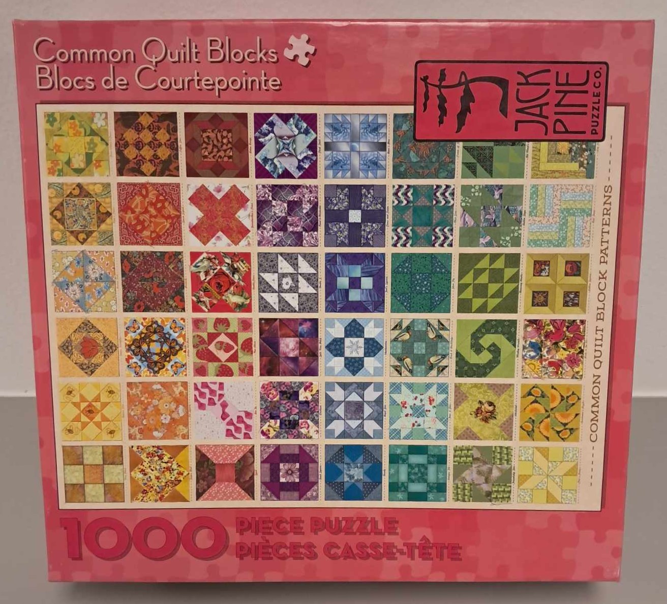 Puzzle cover showing an image of different quilt patterns in many different colors.
