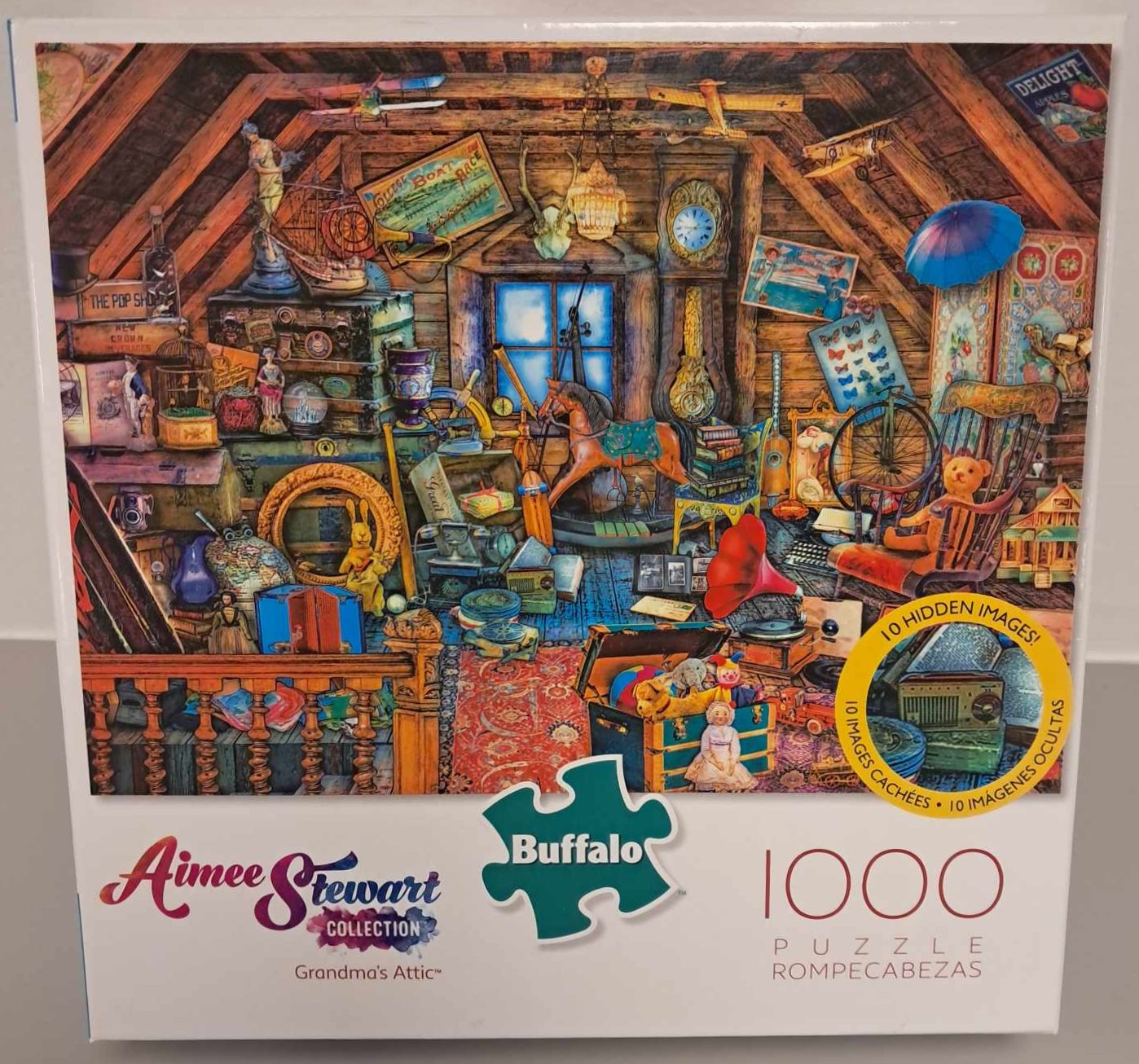Puzzle cover showing a drawing of a cluttered attic with an assortment of objects like a rocking horse, various paintings, and toys.
