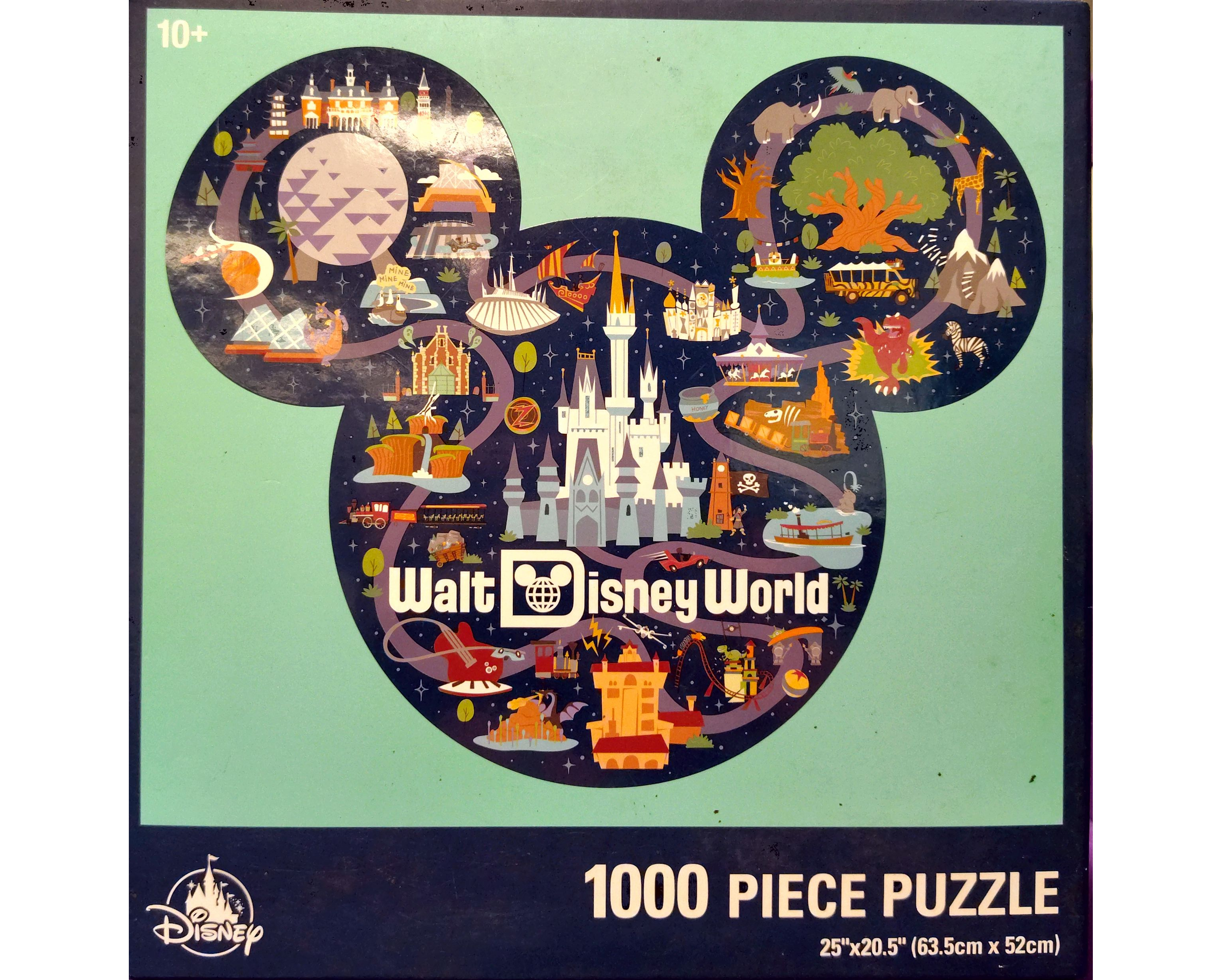 Puzzle cover in the shape of a Mickey Mouse head showing drawings of different locations at Disney World like Epcot, Magic Kingdom and Cinderella's castle.