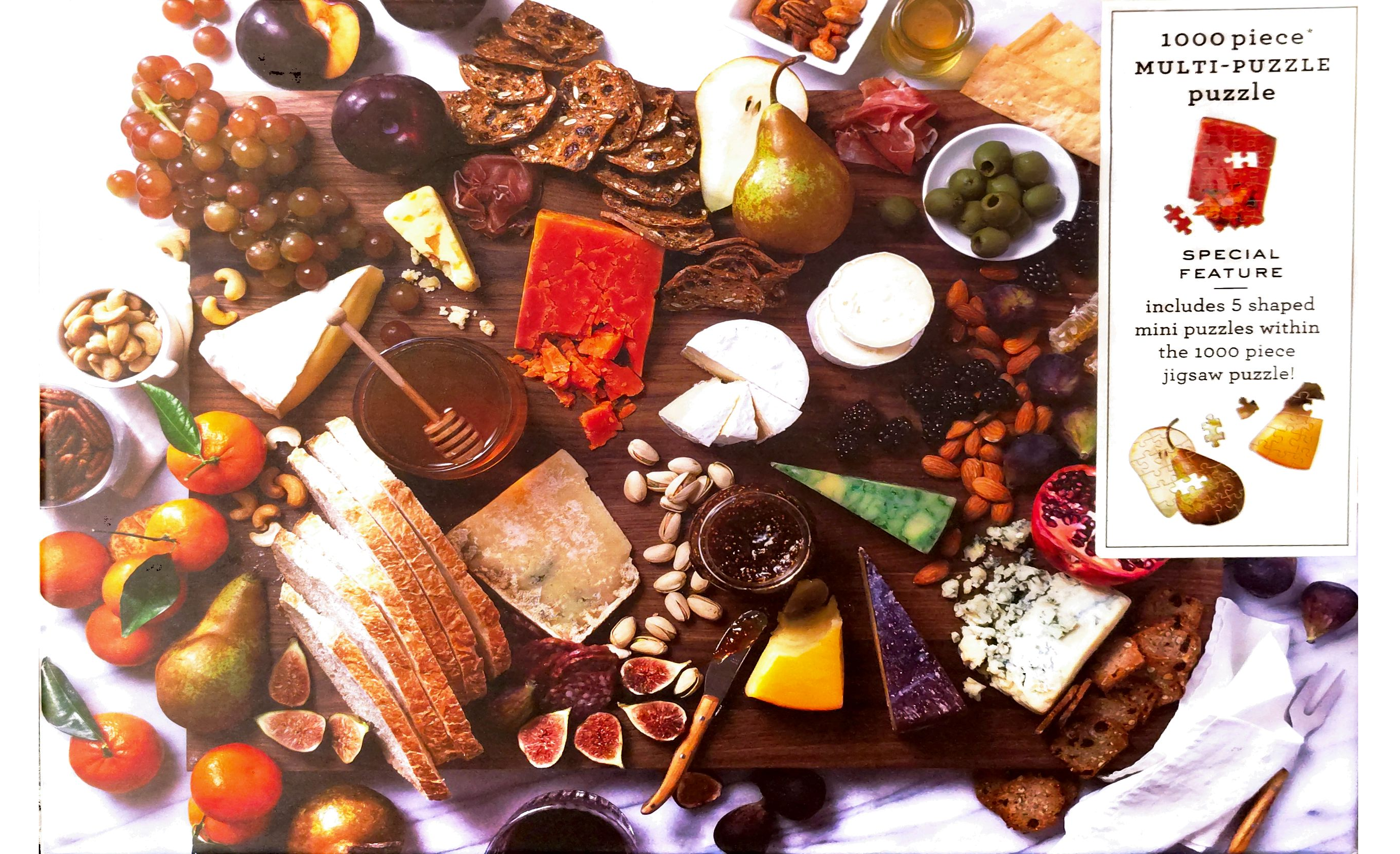 puzzle cover showing a cheese board with different cheeses, crackers, bread, and snacks displayed.