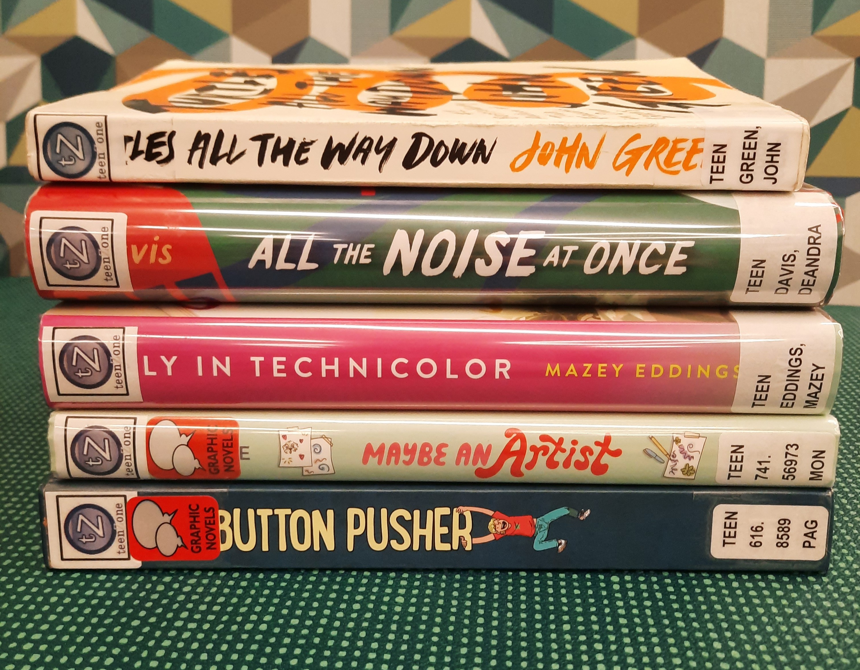 Stack of books that fit the theme of Neurodiverse Novels