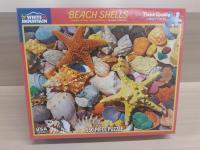 Image of a puzzle cover showing a variety of different shells and starfish.