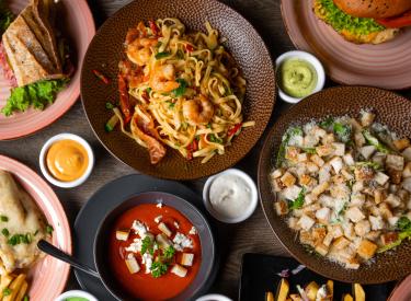 Multiple Dishes of food including soup, french fries, burgers, and sandwiches.