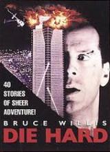 Cover of the movie "Die Hard". Bruce Willis is looking at a skyscraper and there is an explosion on the roof. 